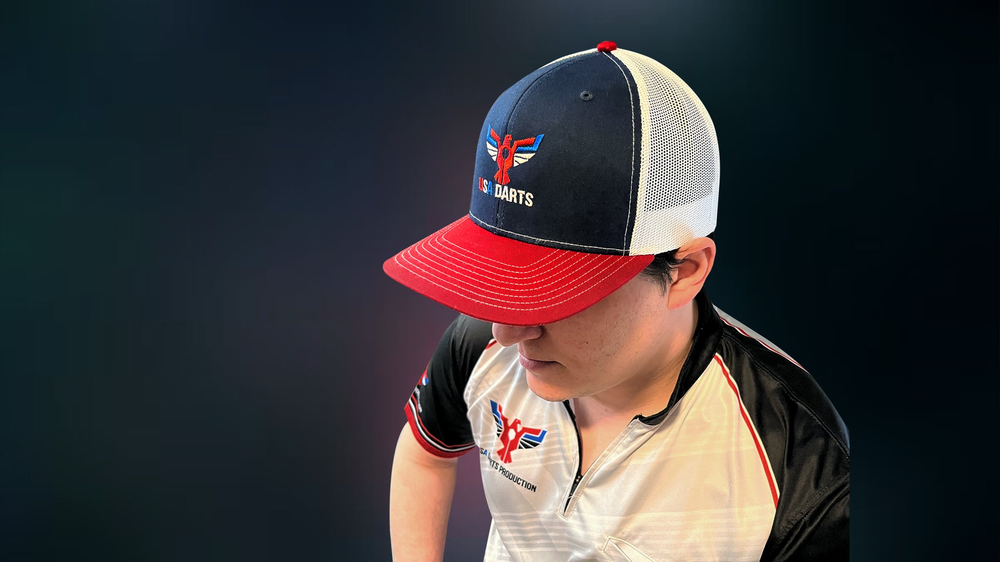 Will Stuart wearing a USA Darts Richardson 112 Red, White and Navy Blue trucker hat.
